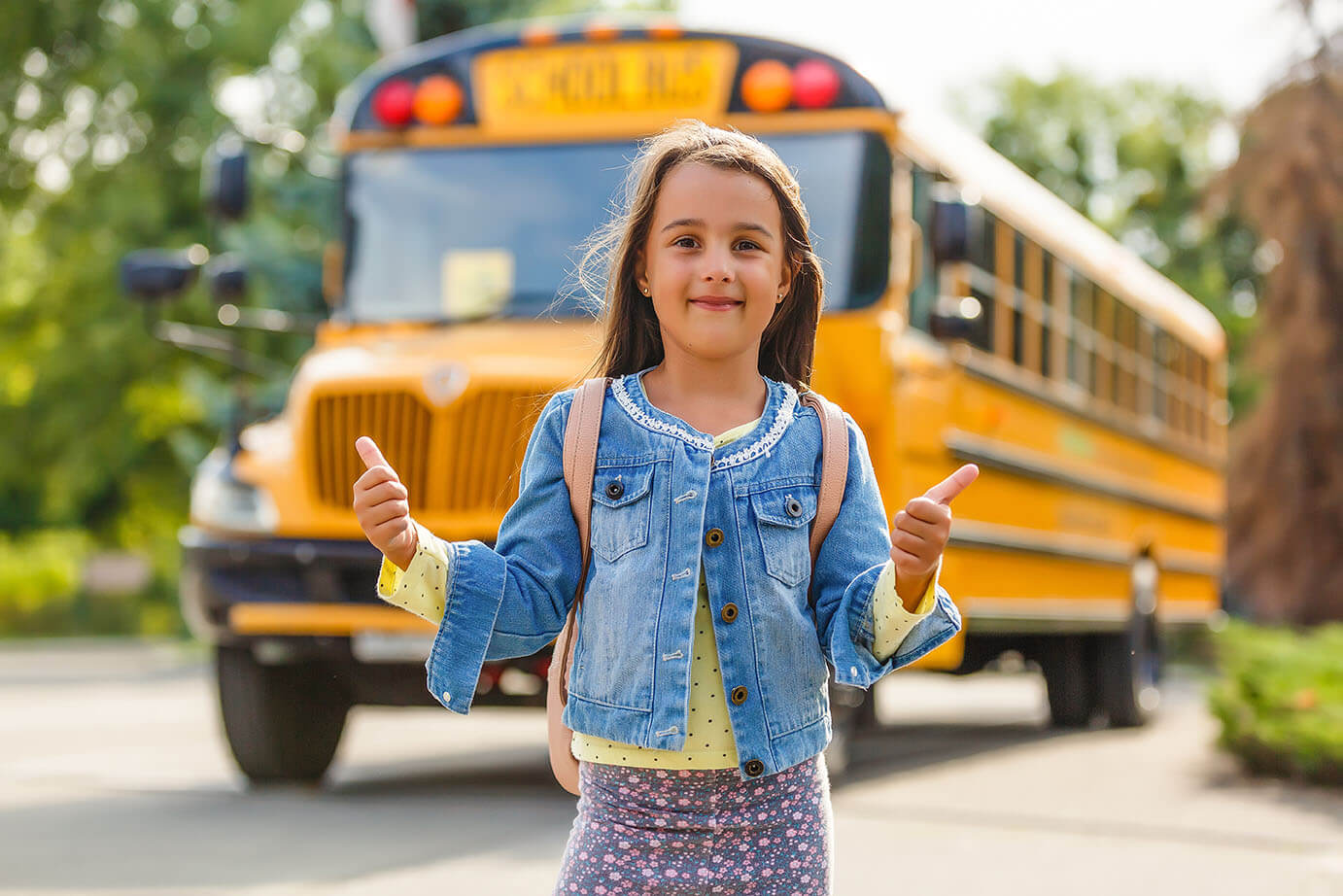 Student in front of school bus